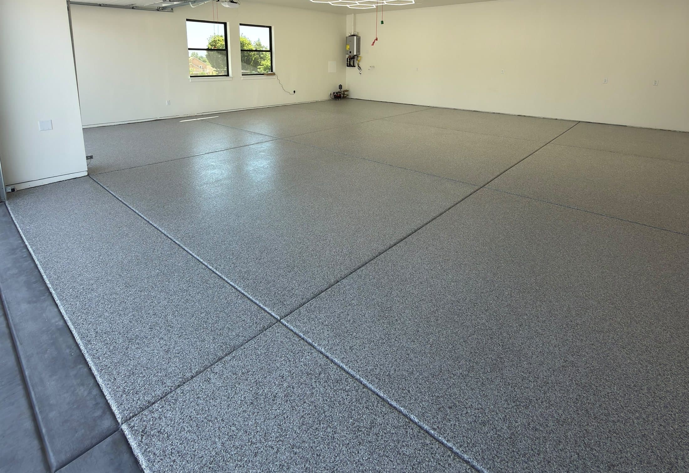 The same garage after installation, finished in a grey flake floor.